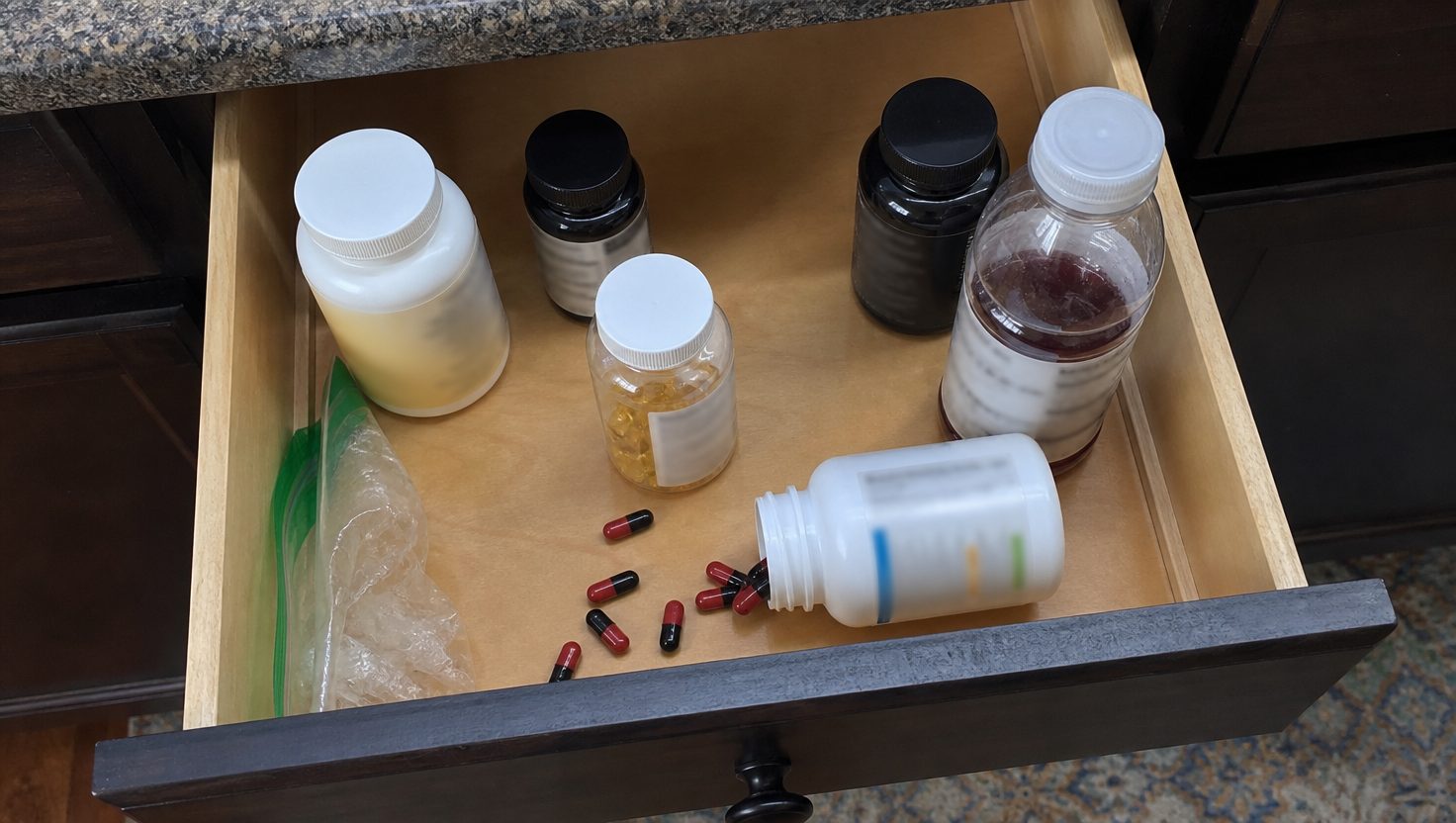 A drawer of supplement bottles
